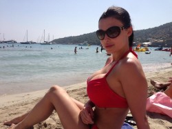 Aletta Ocean in red bikini on Ibiza beach