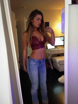 selfy of MFC Niki Skyler in tight jeans and tiny bordeaux top