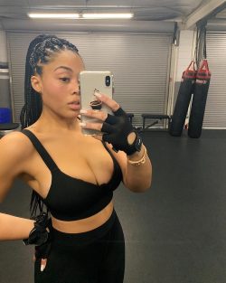 Jordyn Woods showing cleavage in gym outfit
